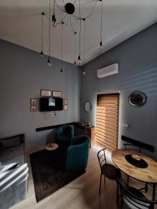 a living room with a table and a couch at Apartman Duga in Kula