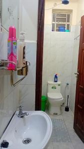 a bathroom with a sink and a toilet at Jayson Homes in Thika