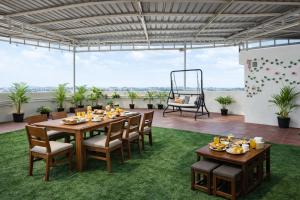 a dining table and chairs on a patio at Harvey's Brookefield-With Free Car Parking in Bangalore
