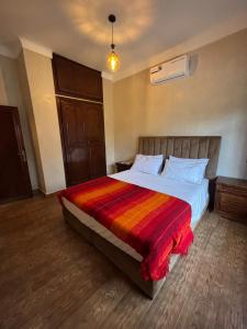 a bedroom with a large bed with a colorful blanket at Villa Ama in Marrakesh +13 photos