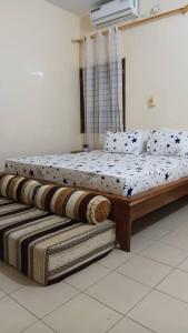 a bedroom with two beds in a room at Résidence Fatima in Tambacounda