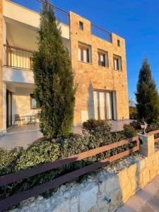 a brick building with a fence in front of it at Daniel's Hotel Apartments in Paphos