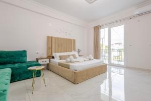 a bedroom with a large bed and a couch at Golden Hill Ksamil in Ksamil