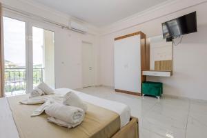 a bedroom with a bed with towels on it at Golden Hill Ksamil in Ksamil