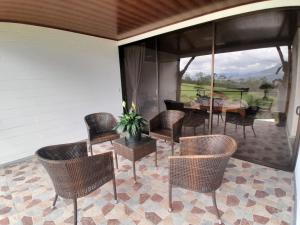 a screened porch with chairs and a table and a table at RIGE s Home in Palma