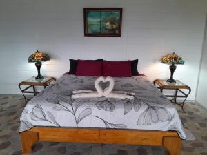 a bedroom with a bed with two swans on it at RIGE s Home in Palma