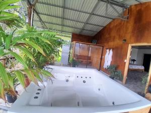 a large white bath tub in a room with plants at RIGE s Home in Palma