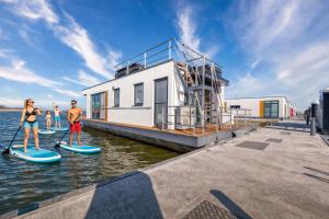 a group of people on paddle boards in the water at Floatinghouse Große Freiheit in Ribnitz-Damgarten