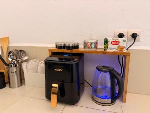 a coffee table with a coffee maker on a counter at RiadTiznitSouss Votre oasis privée à Tiznit in Tiznit