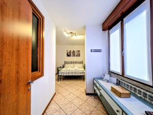 a room with a bedroom with a bed and a window at Popi House in Menaggio +1 photo