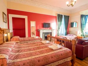 A bed or beds in a room at Corstorphine Lodge Hotel