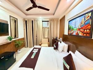 a hotel room with a bed and a flat screen tv at Hotel Oxygen La Vida-Noida Sector 18 in Noida +42 photos