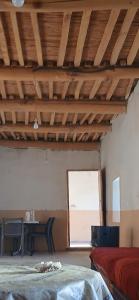 a room with a bed and a table and a window at ZAZA Guest house in Agoudal