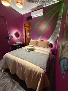 a bedroom with a bed with purple walls at Morada do Boto in Santarém