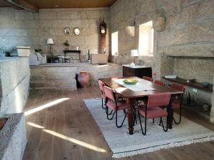 a kitchen and dining room with a table and chairs at Casa do Cabo in Ribeira de Pena