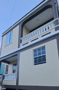 a white building with windows and a balcony at Azille's Apt in Portsmouth