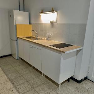 a kitchen with a sink and a refrigerator at Casa Vega-Marrero in Arucas