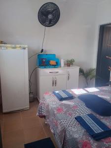 a bedroom with a bed and a fan on the wall at Hospedagem Campestre da Dutra 01 in Barra Mansa