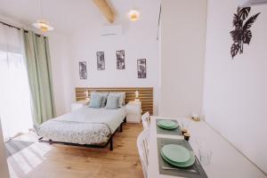 a bedroom with a bed and a table with green plates on it at L'extension - Studio in Aussonne