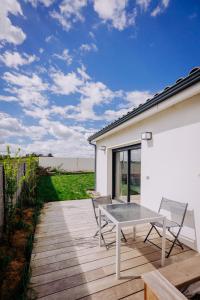 a patio with a table and chairs on a deck at L'extension - Studio in Aussonne