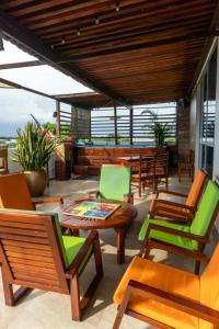 a patio with wooden chairs and a table and chairs at Hotel Ucla Center in Valledupar