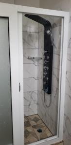 a shower in a bathroom with a stone wall at Azille's Apt in Portsmouth +13 photos