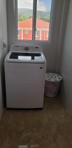 a white stove in a room with a window at Azille's Apt in Portsmouth