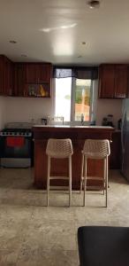 a kitchen with two chairs and a kitchen counter at Azille's Apt in Portsmouth