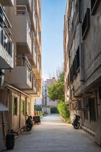 an alley between two buildings with motorcycles parked at Harvey's Brookefield-With Free Car Parking in Bangalore