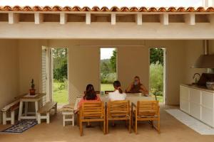 two women sitting at a table in a house at A Casa do Olival in Mealhada