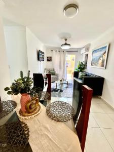 a dining room with a table and a living room at Moderno Apartment Near the Ocean Santo Domingo Este Wife ,AC in La Francia