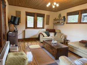 a living room with a couch and a coffee table at Wharfe Lodge - complimentary spa access in Skipton