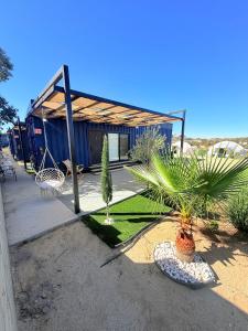 a house with a basketball hoop and some plants at Cabañas aldebaran cienega redonda in Hechicera