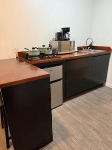 a kitchen with a counter with pots and pans on it at Cabañas aldebaran cienega redonda in Hechicera