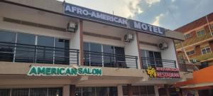 an american salon sign in front of a building at Afro-American Motel in Kampala