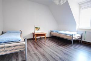 a room with two beds and a table in it at Ferienwohnung Kaspar mit Parkplatz in Pforzheim