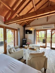 a bedroom with a living room with furniture and a fireplace at D'EMILION De SENS in Gardegan-et-Tourtirac