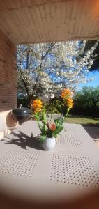a table with a vase of flowers on it at La Casa delle Ciliegie in Assisi
