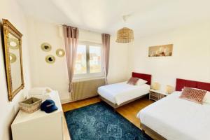 a bedroom with two beds and a window at Shalhome 1 Comfort at the gates of Strasbourg in Lingolsheim