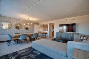 a living room with a bed and a dining room at DoubleTree by Hilton Poughkeepsie in Poughkeepsie