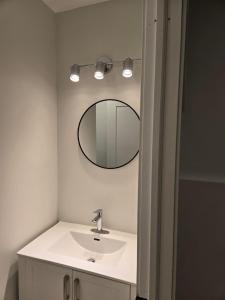 a bathroom with a sink and a mirror at Bournas Nest in Hammonds Plains