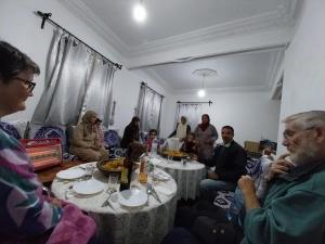 a group of people sitting around a table at Maison du Bonheur berbère in Aït Ougliff