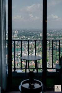 a table in a room with a view of a city at Luxury Trizen Aki Apartments in Colombo