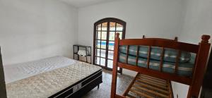 a bedroom with two bunk beds and a window at Chácara Segatelli in Cotia