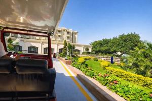a train traveling past a house with a garden at Grand Tibarose Hotel in Cairo