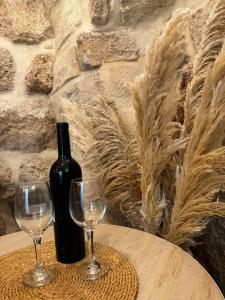 a bottle of wine and two glasses on a table at Calamari Suite in Acre
