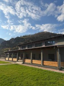 a building with a hill in the background at Cabana Piatra Buru in Buru