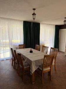 a dining room with a table and chairs at Cabana Piatra Buru in Buru +37 photos