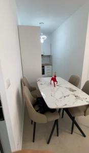 a toy monkey sitting on a table in a room at Golem luxury apartment in Golem