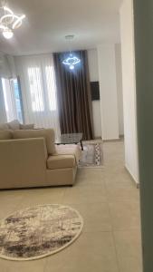 a living room with a couch and a table at Golem luxury apartment in Golem
